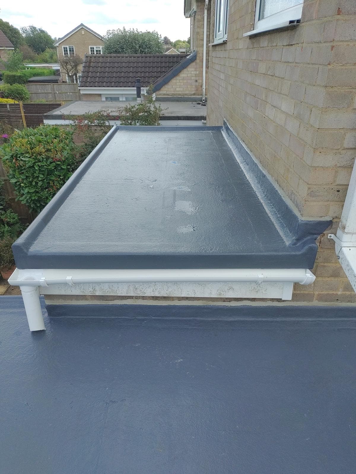 Charcoal flat roof with guttering