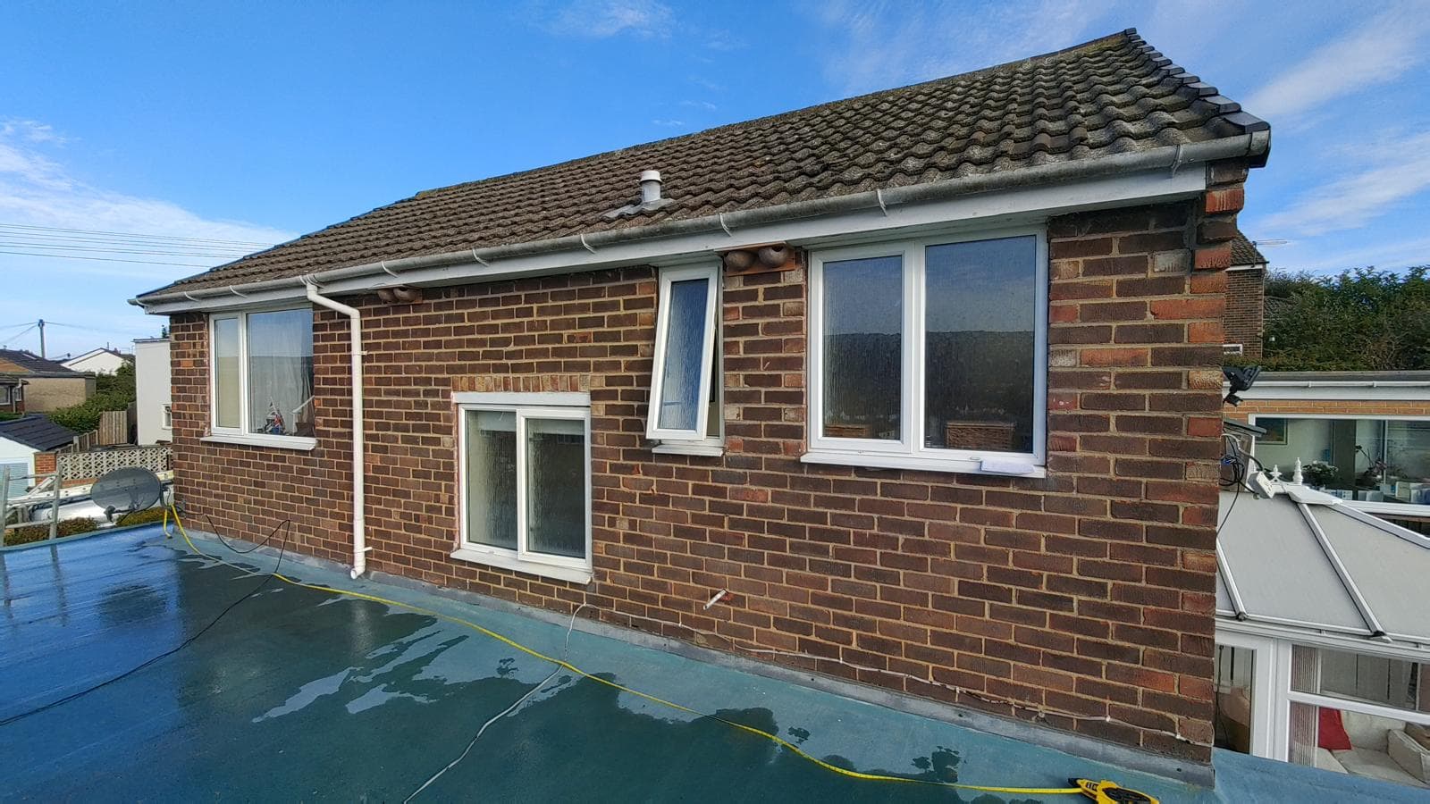 Pitched tile and flat roof brick house