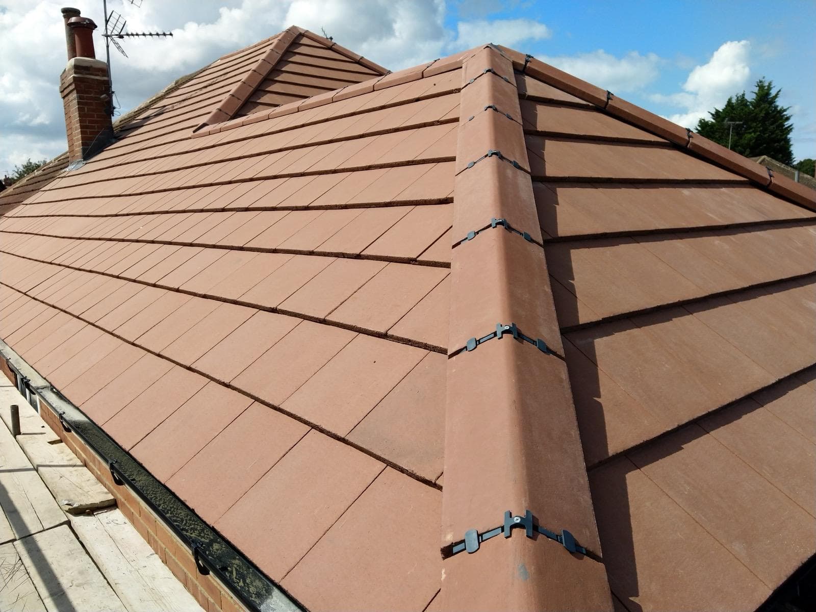 Terracotta tile roof hip ridge installation